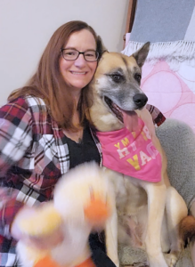 Kelly sitting with Essen, a dog she fostered through GHS.